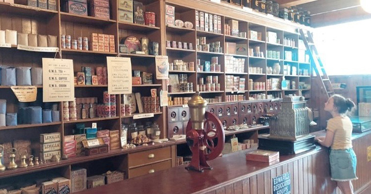 little girl inside 1900s town shop at Beamish Museum